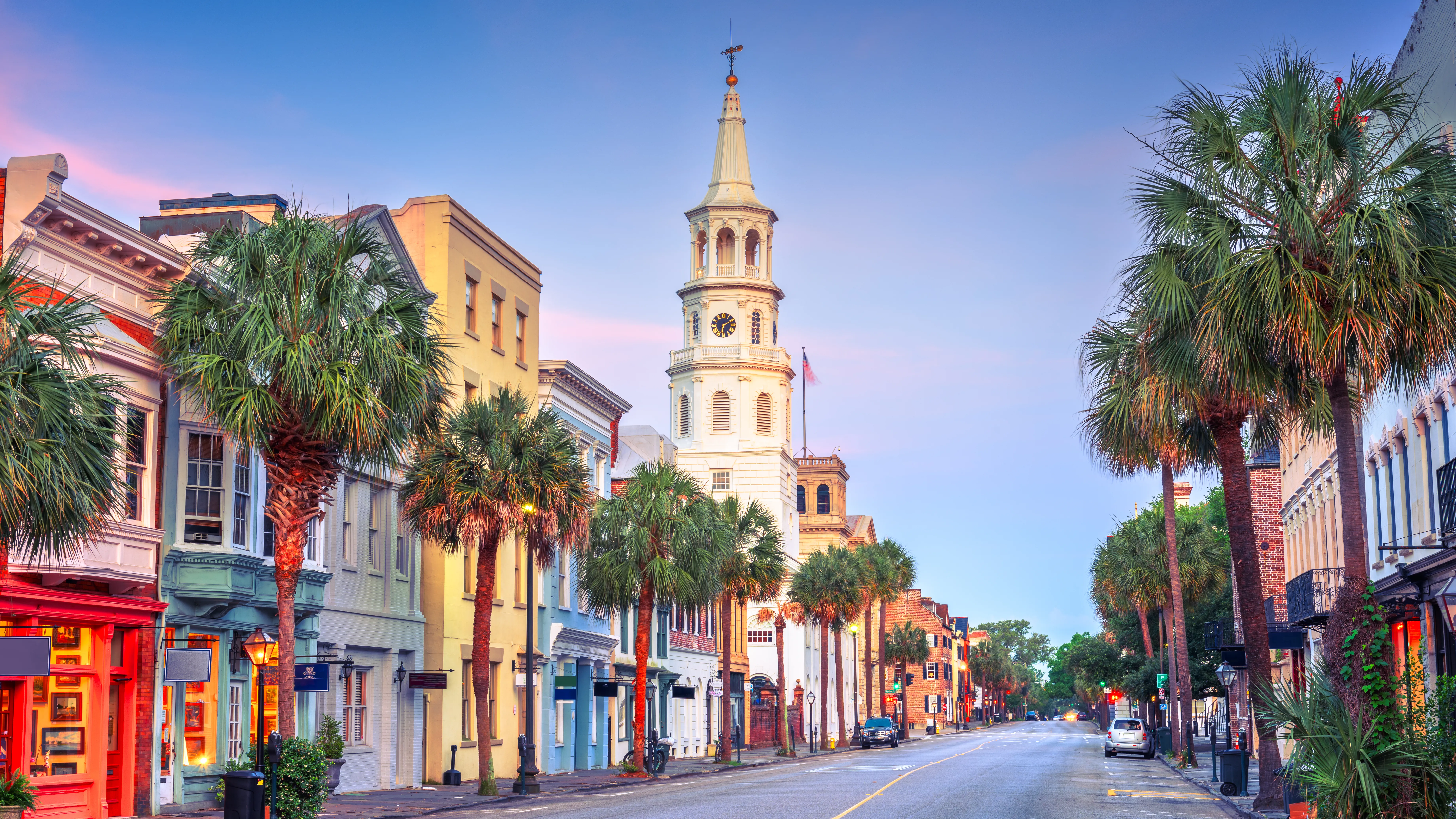 Historic downtown street lined with palm trees and church steeples